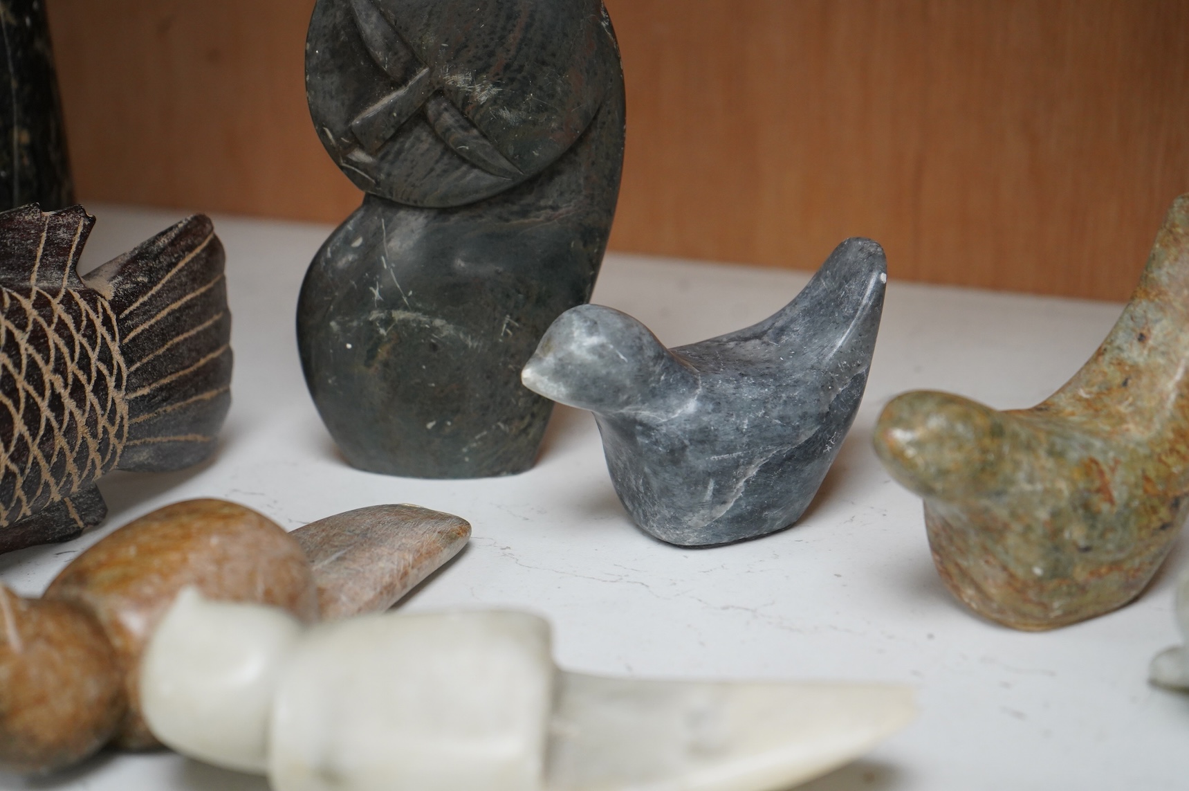 Eleven Inuit related stone carvings, unsigned, to include birds and abstract figures, largest 22cm high